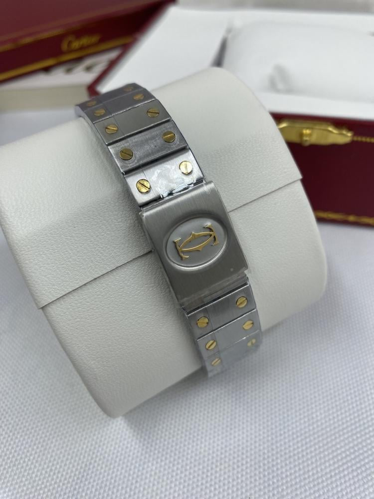 Montre  Cartier Santos Ronde
Très bon état
Argenté, Or et acier